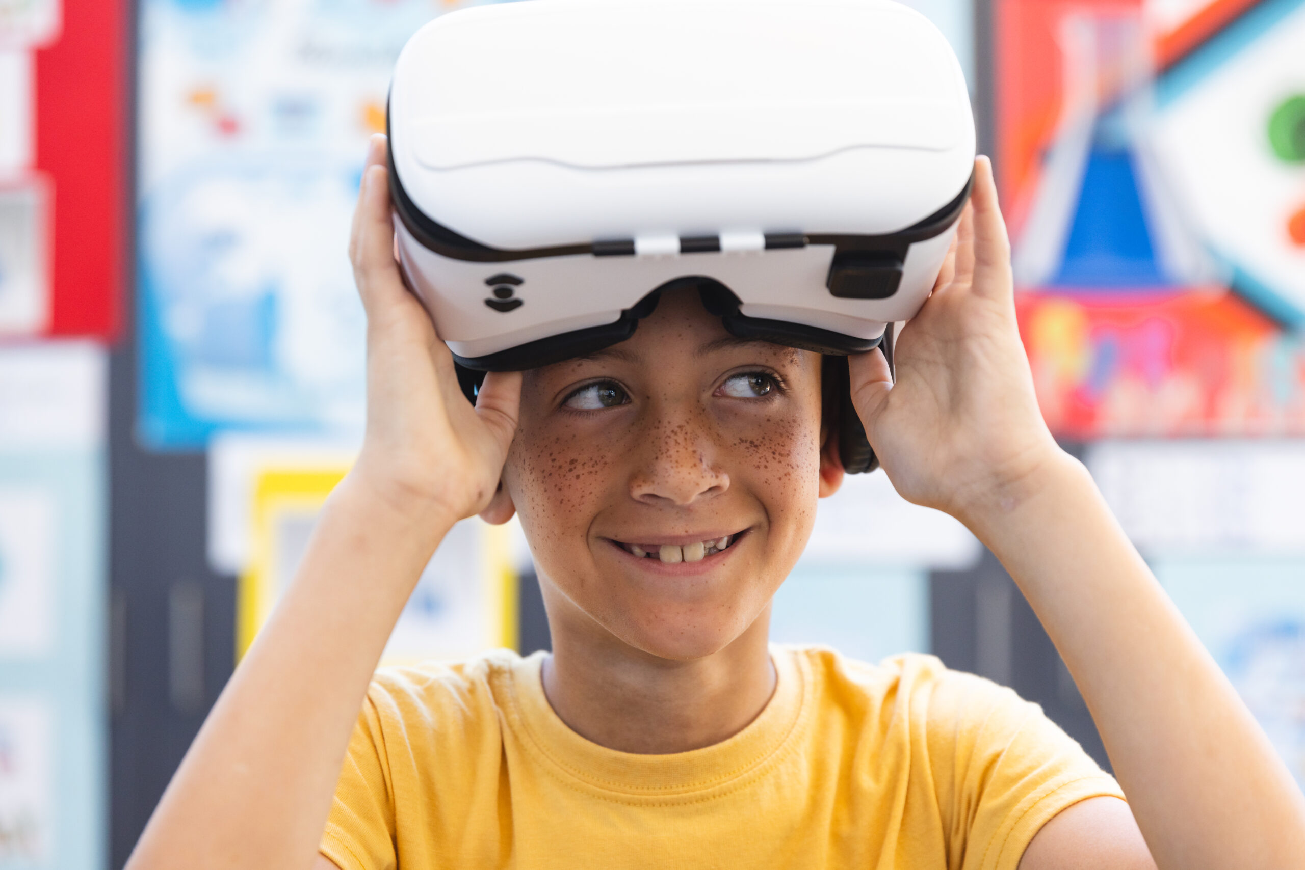 Boy explores virtual reality in a classroom at school. His excitement is evident as he engages with innovative educational technology.